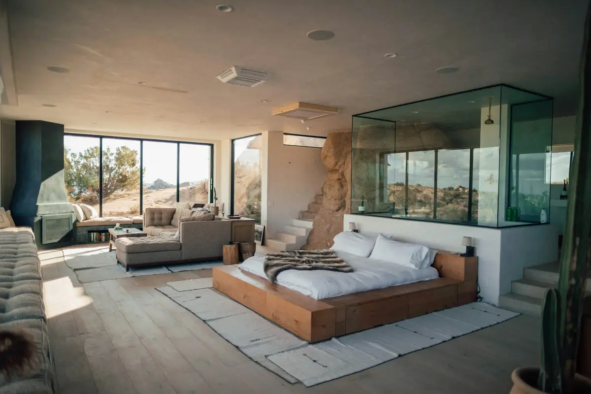 A designer bedroom with a glass partition