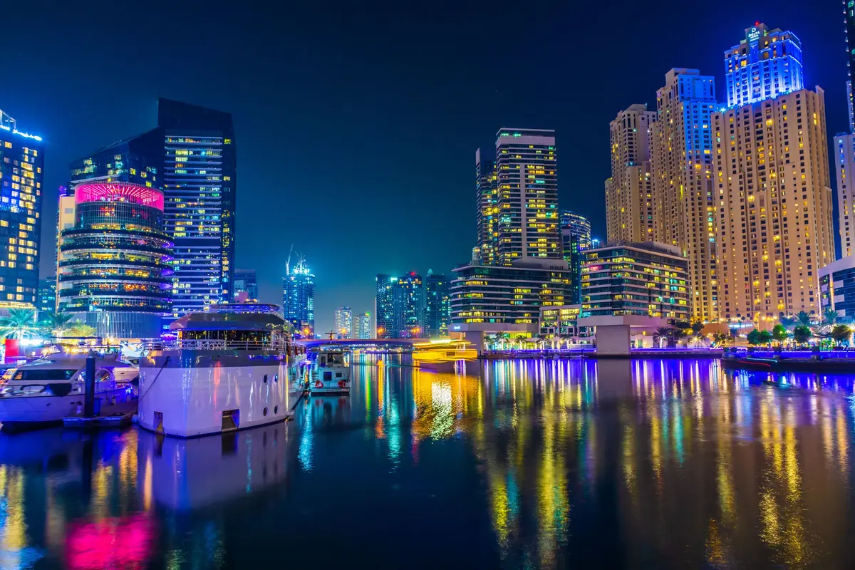 Dubai Marina after dark, tower lights reflected in the water