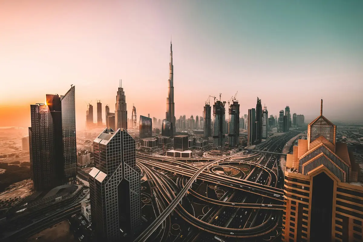 Downtown Dubai towers and Sheikh Zayed Road at sunset, with the Burj Khalifa on the skyline